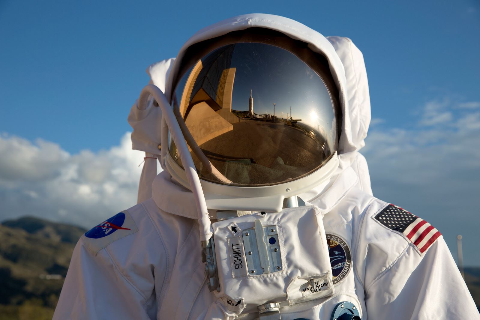 Astronaut with the Museum of Space History reflected in the helmet visor.