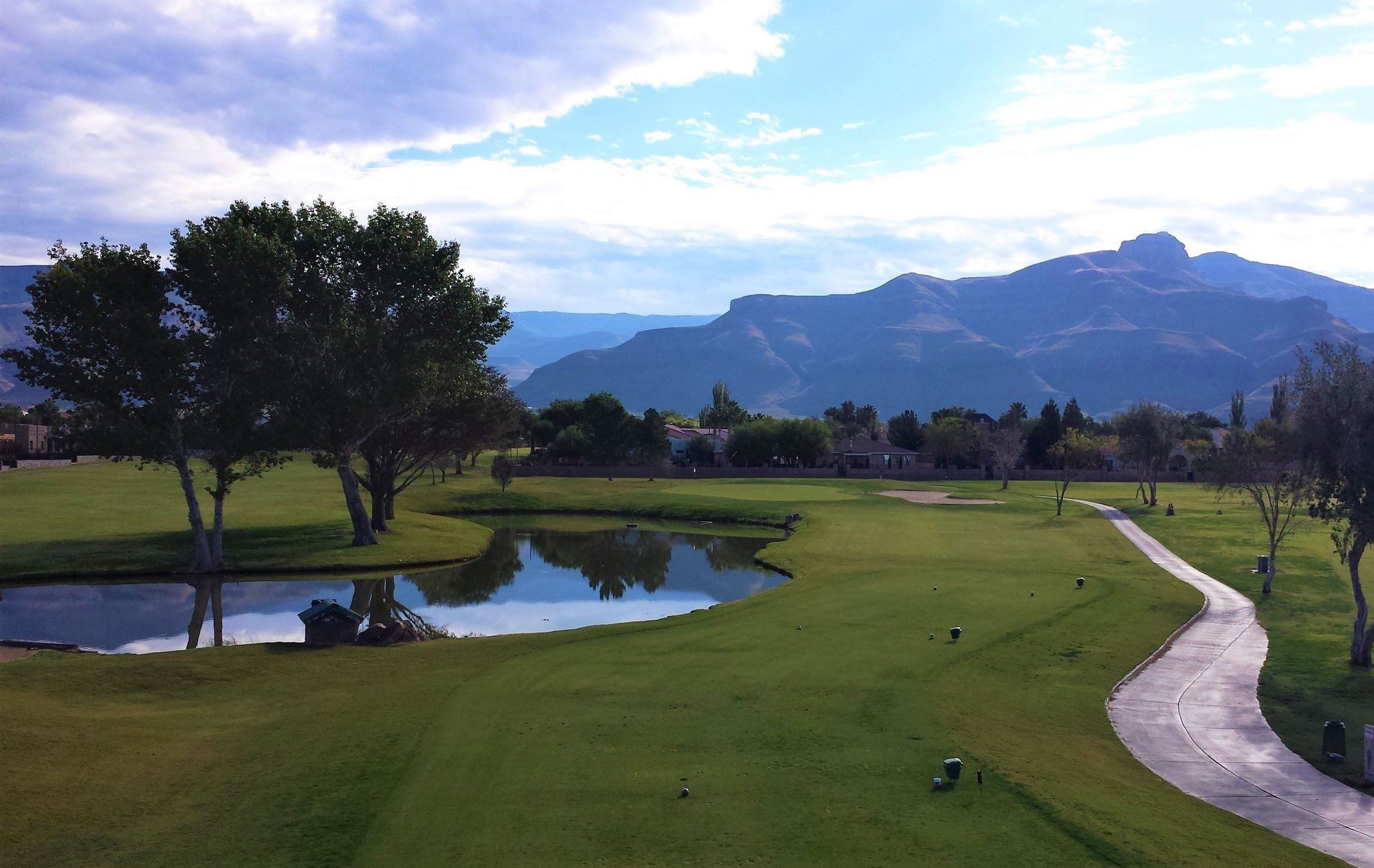 The Desert Sands golf course with mountains in the background.